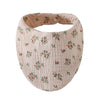 A light pink organic cotton muslin baby bib with a textured pattern and absorbent band.