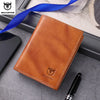 A brown genuine leather men's bifold wallet with stitching and a logo, placed next to a black pen.