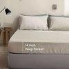 A close-up of a beige linen fitted sheet with 14 inch deep pockets on a bed.