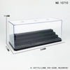 A clear acrylic display case with a black base and a slotted interior, shown from above.