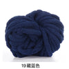 A ball of dark navy blue chunky acrylic yarn for knitting and crochet