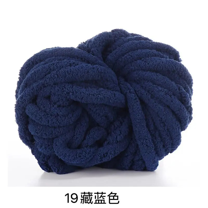 A ball of dark navy blue chunky acrylic yarn for knitting and crochet