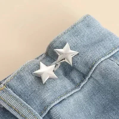 Silver star brooch belt buckle clipped onto a denim fabric