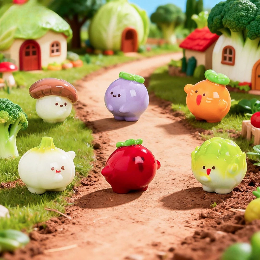 A collection of hand-painted resin vegetable figurines, including a mushroom, eggplant, tomato, and squash, arranged on a dir