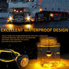A close-up of a round LED side marker light illuminating water droplets, demonstrating excellent waterproof design.