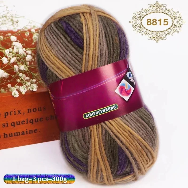 A ball of gradient dyed wool blend yarn in various shades including brown, purple, and green.