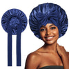 A woman models a royal blue satin silk sleep bonnet, showing the fabric and design.