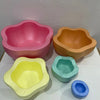 Five brightly colored plastic stepping stones in pink, orange, yellow, green, and blue for sensory and motor skill developmen