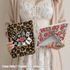 A person holds a leopard print tri-fold iPad case and a white tablet, with a pink cardigan in the background.
