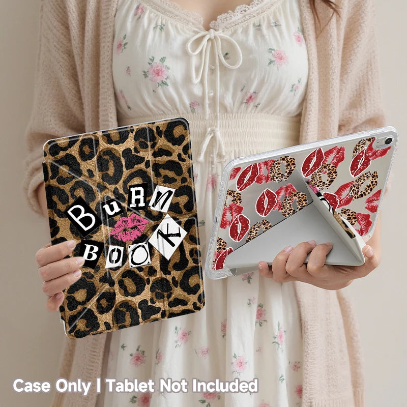 A person holds a leopard print tri-fold iPad case and a white tablet, with a pink cardigan in the background.