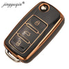 Black TPU silicone car key case with multiple key slots and a gold trim ring.