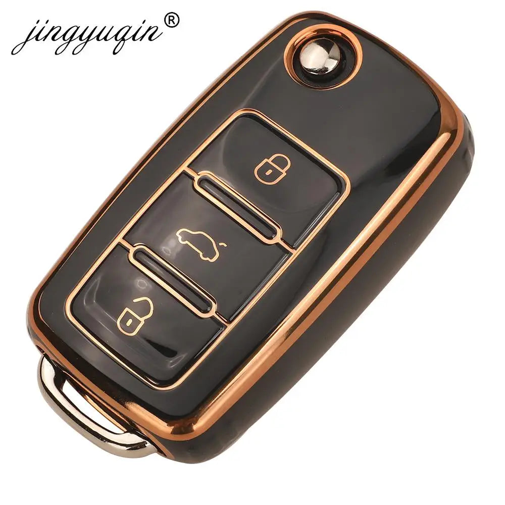 Black TPU silicone car key case with multiple key slots and a gold trim ring.