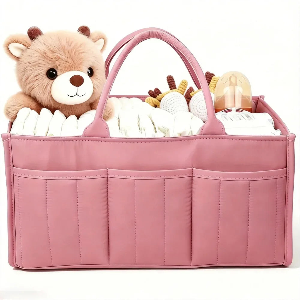 A pink floral diaper organizer bag featuring a teddy bear charm and multiple compartments for baby supplies.