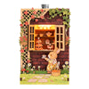 A DIY book nook fridge magnet kit featuring a brick facade, greenery, and a rabbit character with LED lighting.