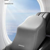 A close-up of a gray memory foam car headrest and lumbar support pillow inside an aircraft seat.