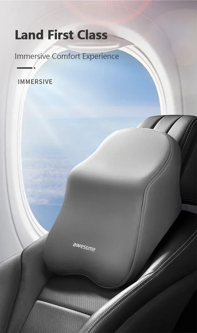 A close-up of a gray memory foam car headrest and lumbar support pillow inside an aircraft seat.