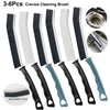 A set of six black and white crevice cleaning brushes for tight spaces.