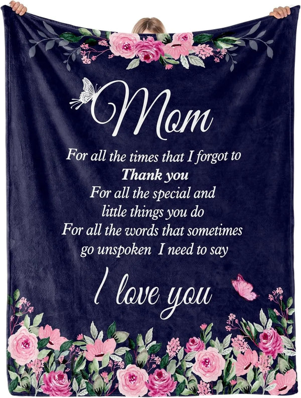 A dark blue fleece throw blanket decorated with pink and purple floral embroidery and the text I love you
