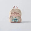A light pink, fuzzy backpack featuring a cute blue Stitch design.