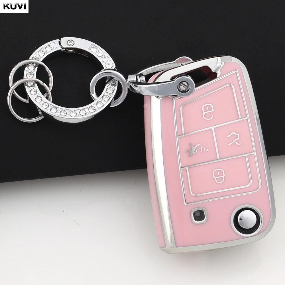 A pink TPU car key cover with a silver keyring attached, featuring various key cutouts.