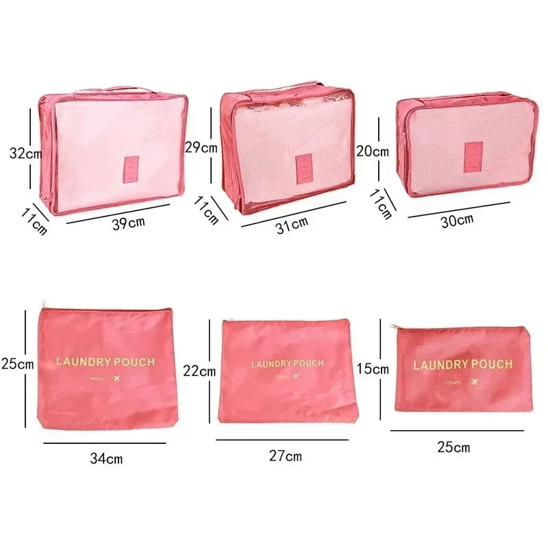 Six pink fabric laundry pouches and packing cubes of various sizes displayed side by side.