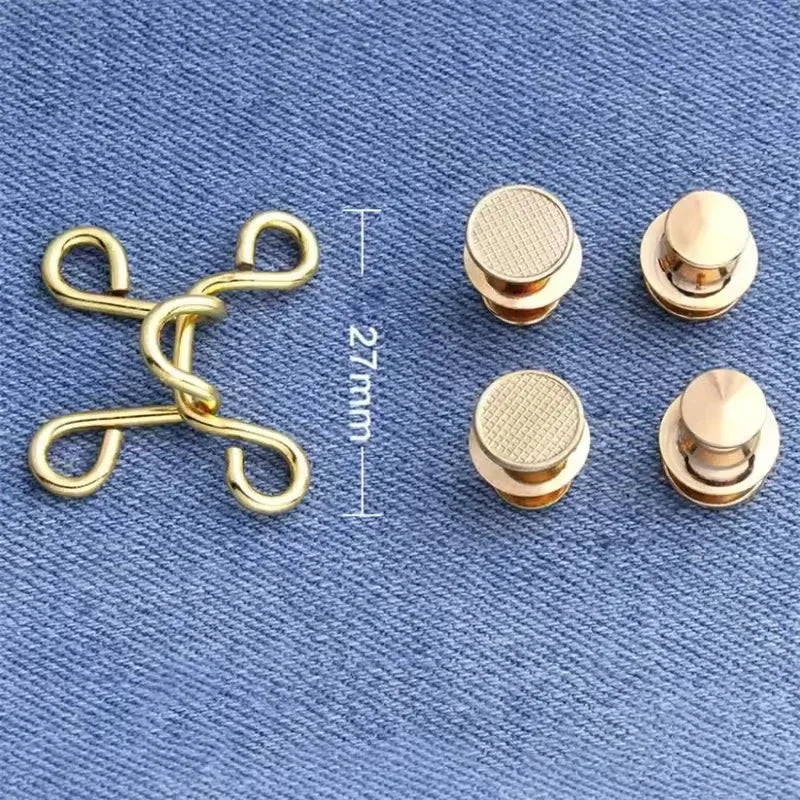 A set of gold-toned metal jeans button snaps for waist adjustments, shown with a measuring scale.