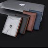A collection of slim RFID-blocking wallets in various colors including gray, black, brown, and blue displayed on a laptop.