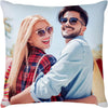 A woman and a man smiling while looking at the camera on a throw pillow cover.
