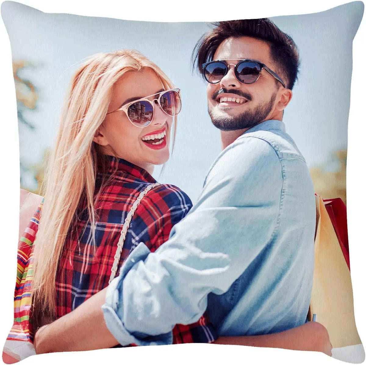 A woman and a man smiling while looking at the camera on a throw pillow cover.