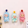 Three plush bunny suction cup hooks in blue, mint green, and pink for hanging items