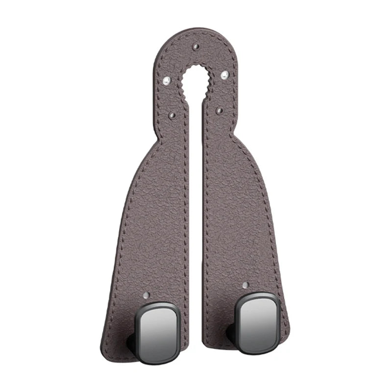 A pair of brown leather headrest hooks designed as a tidy organizer for bags, groceries, and coats.