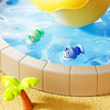 A yellow plastic bucket filled with colorful plastic fish is shown above a shallow pool of blue water.