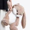A fluffy, light brown angry rabbit plush toy with long ears is being held by a person.
