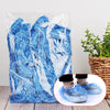 A clear plastic bag filled with blue disposable waterproof shower caps.