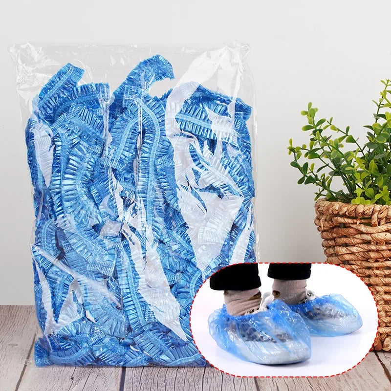 A clear plastic bag filled with blue disposable waterproof shower caps.