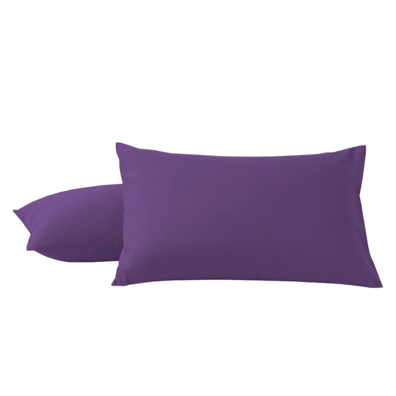 A pair of solid purple microfiber pillowcases with envelope closure.