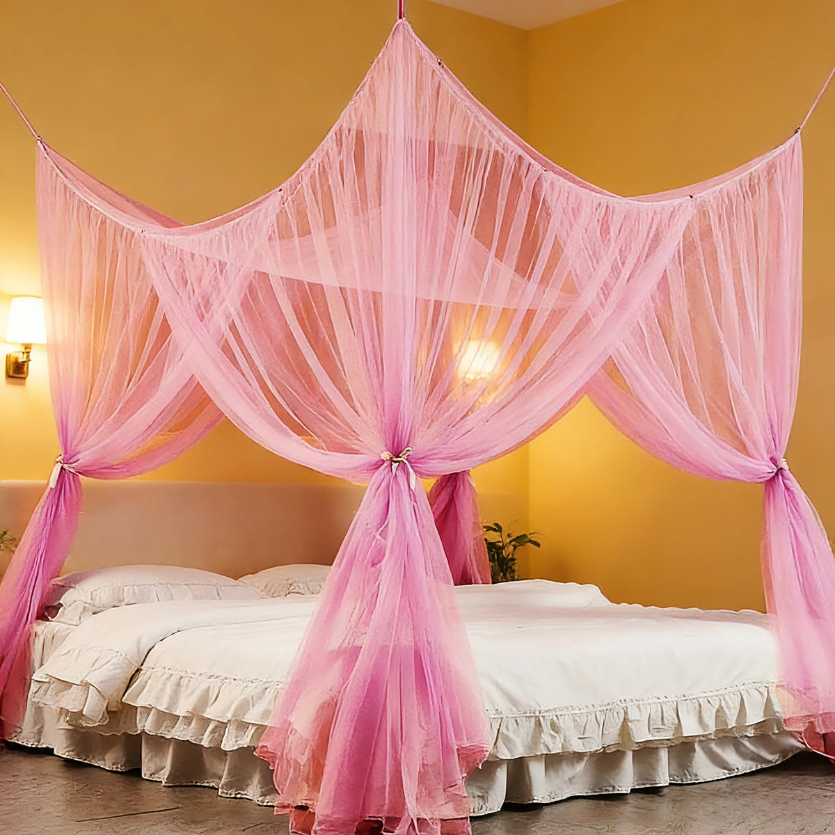 A pink mosquito net bed canopy draped over a white bed in a yellow room.