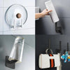 A set of no-punch adhesive hooks used to hang hats, bags, and coats on a wall.