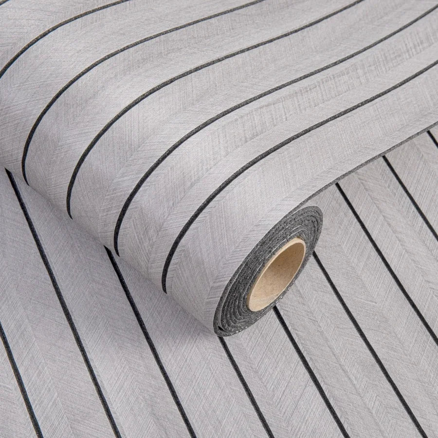 Roll of gray 3D grille pattern peel-and-stick wallpaper showing vertical lines.