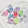 A collection of clear acrylic alphabet beads in various colors and sizes displayed on a white plate.