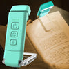 A teal rechargeable clip-on LED book light with a flexible neck resting on an open book.