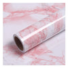 Roll of self-adhesive pink marble wallpaper featuring natural veining for furniture and countertop decoration