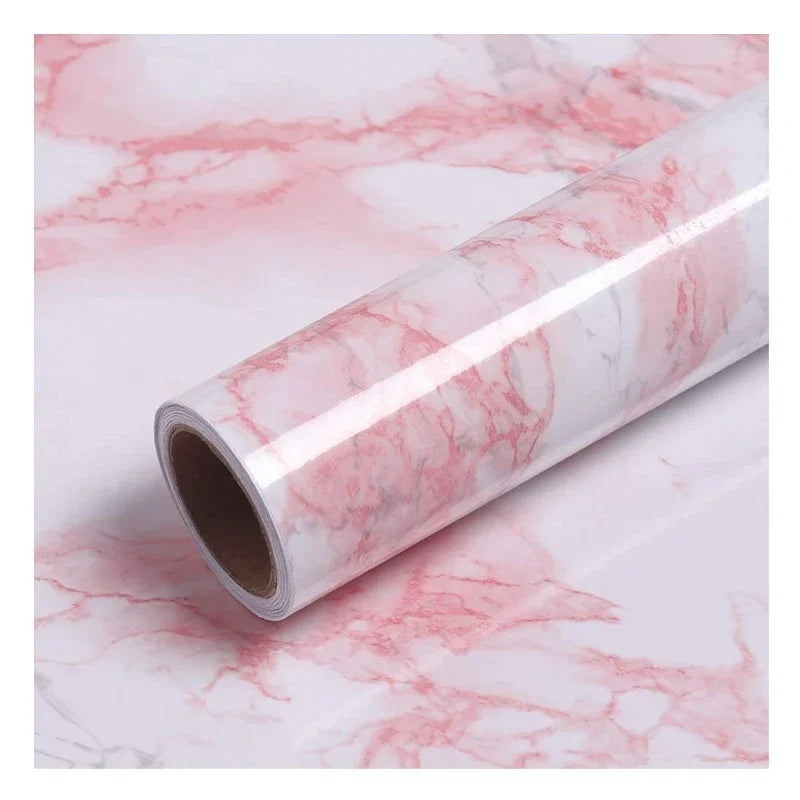 Roll of self-adhesive pink marble wallpaper featuring natural veining for furniture and countertop decoration