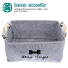 Gray felt pet toy storage basket with wooden handles labeled Dog Toys