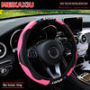 Pink carbon fiber steering wheel cover for a car, shown inside the vehicle cockpit.