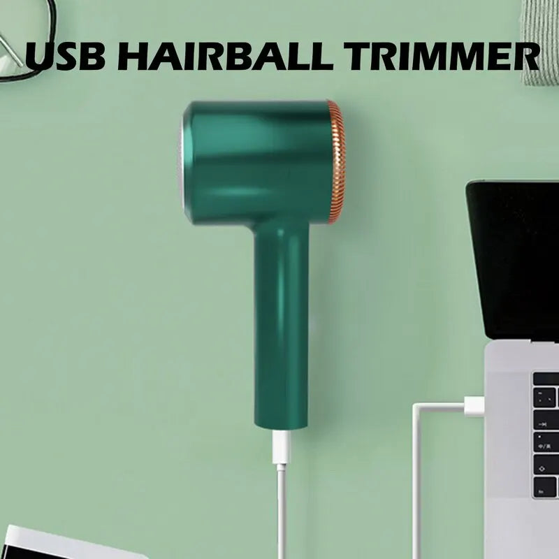 A teal USB hairball trimmer is mounted on a wall, next to a white electric lint remover.