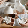 Hands sculpt detailed floral designs in white air-dry clay on a wooden surface.