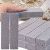 A hand is holding a gray pumice stone cleaning stick, showing its texture and size.