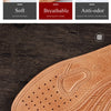 A close-up view of genuine leather insoles for men showing the breathable perforated design.