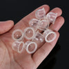 A hand holds a clear plastic bulb kit containing various carburetor primers for power tools.